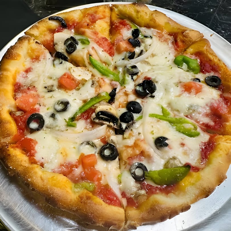 Al Dente Pasta & Pizza's veggie pizza, topped with olives, green peppers, onions, and tomatoes.