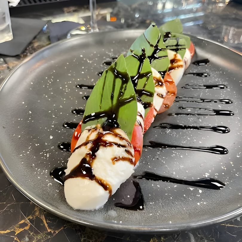 Al Dente Pasta & Pizza's Caprese salad with fresh mozzarella, tomatoes, basil, and balsamic glaze.